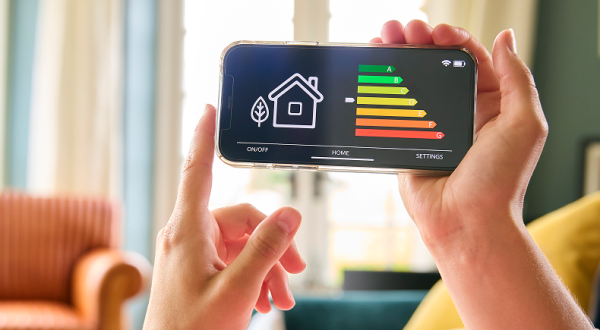 close-up-woman-looking-screen-energy-efficiency-meter-mobile-phone-lying-sofa-home 1